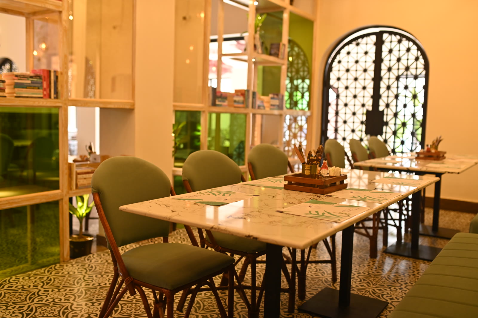 Inside Th&eacute;&acirc;tre Lahore &mdash; bistro chairs along the tiled floor